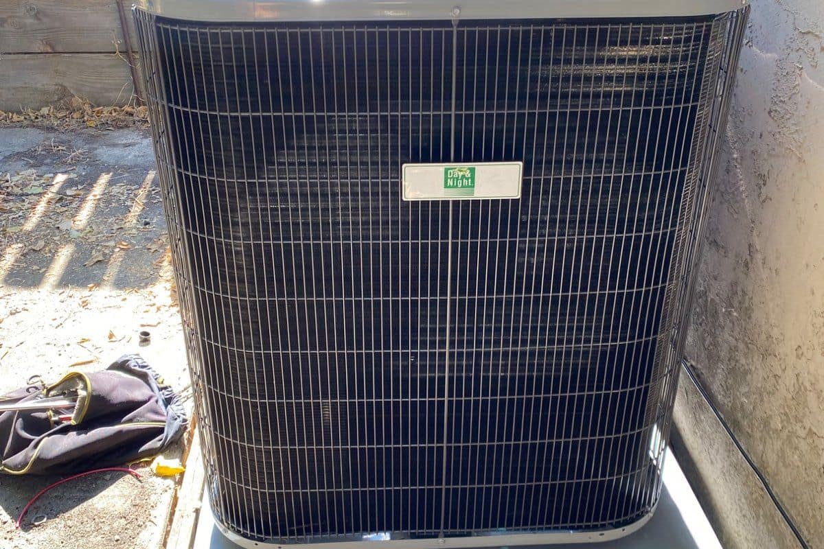 Wall-mounted air conditioner cooling a bright modern living room ahead of summer