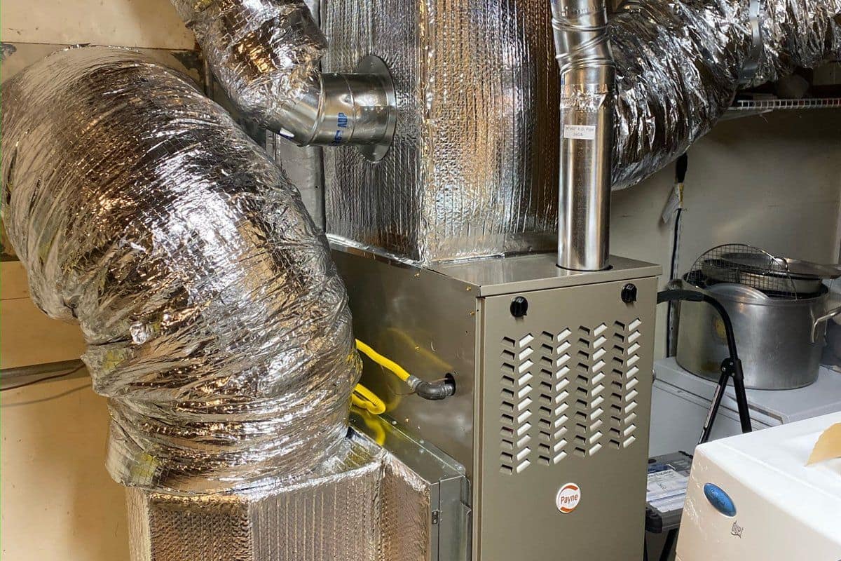 Insulated flexible duct reconnected and sealed at a residential furnace during a duct repair